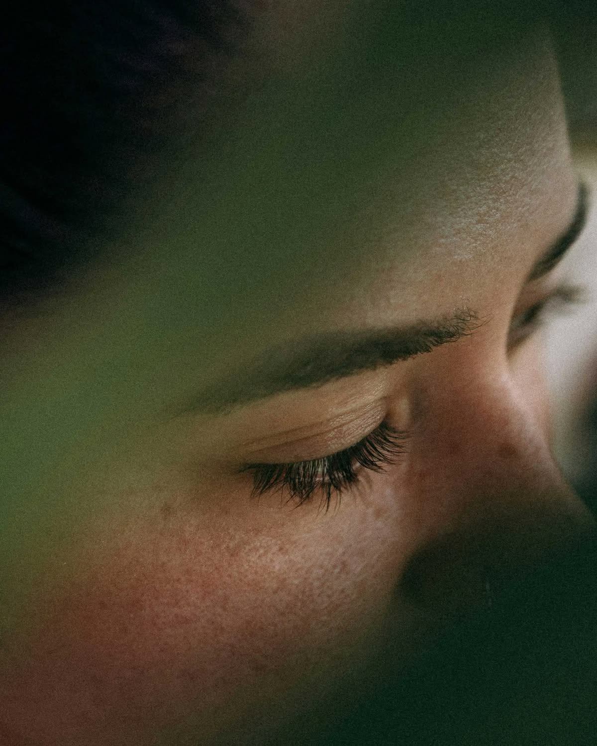 Close-up portrait, eyes closed in warm light