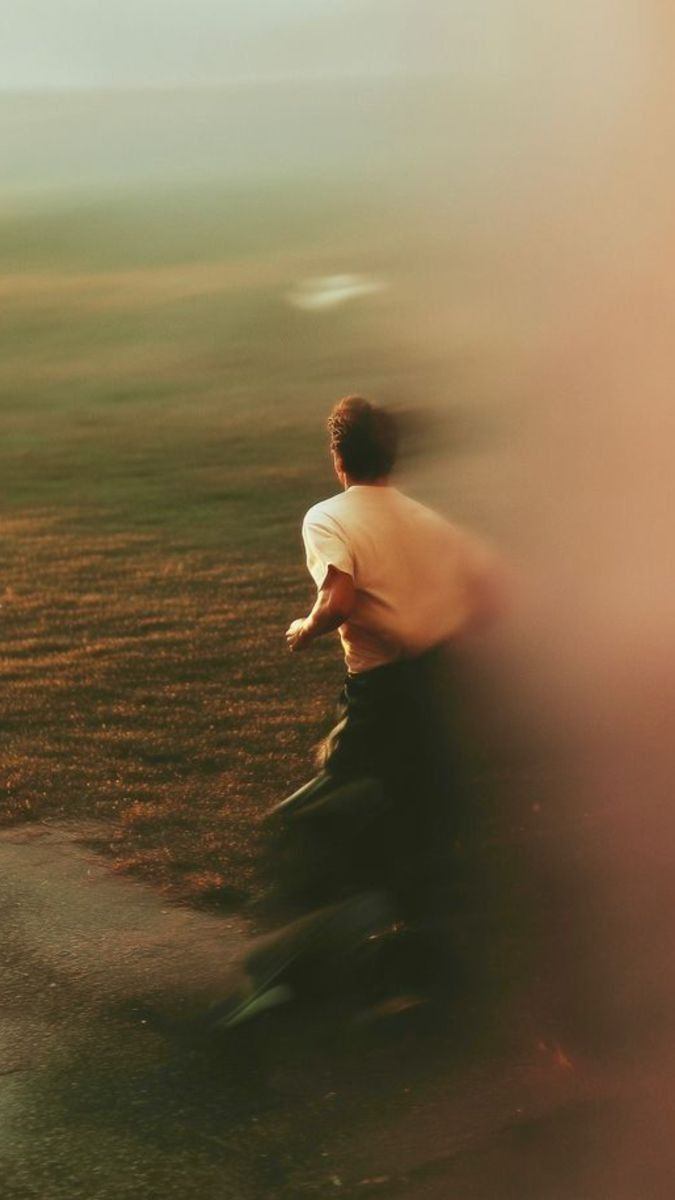 Person running through a golden field
